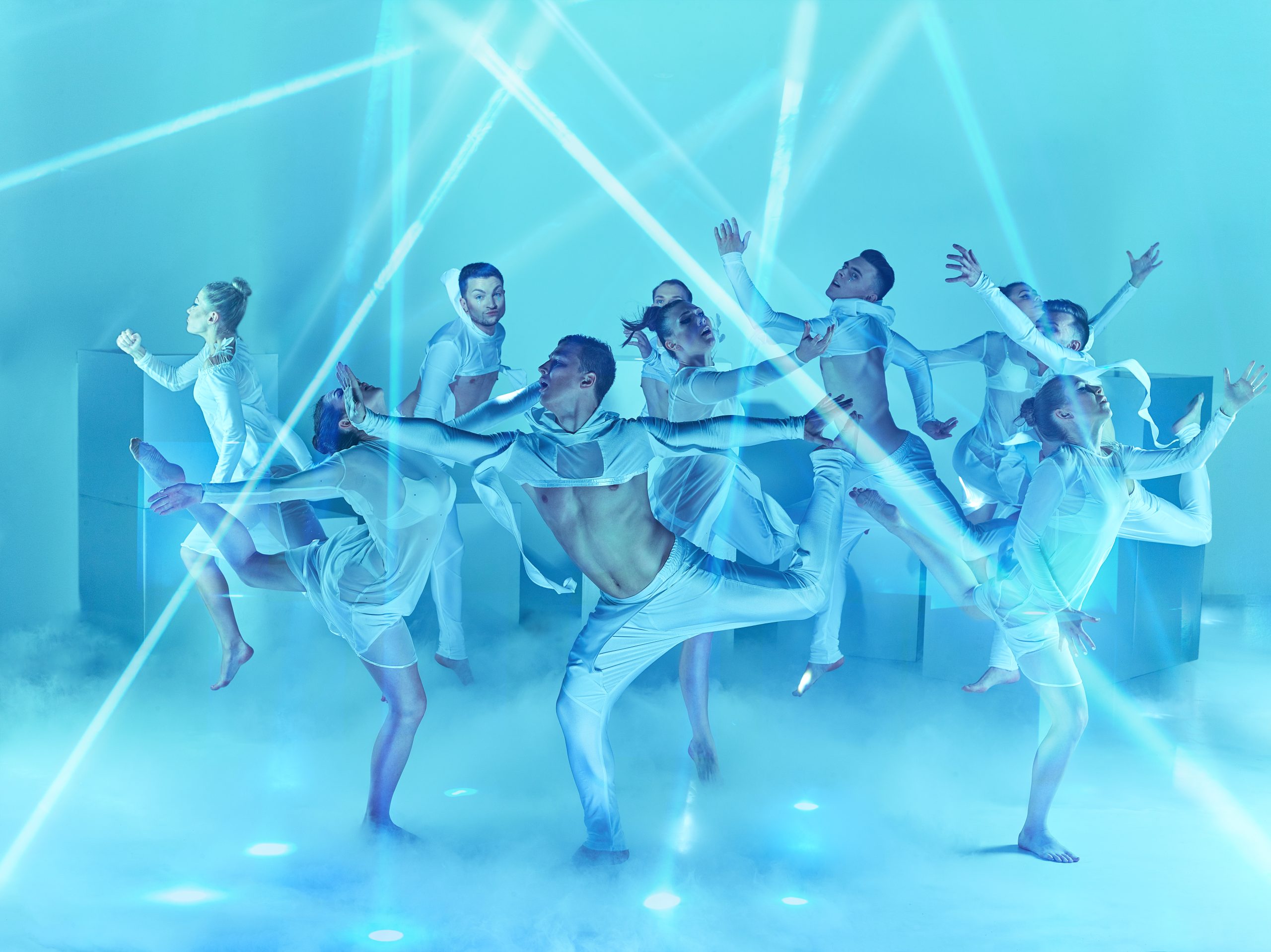 The group of modern ballet dancers on blue studio background
