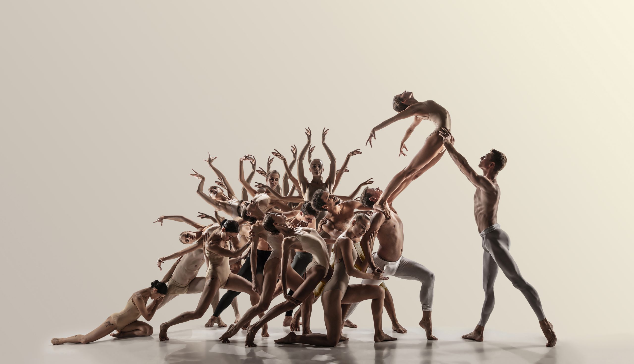 Support. Group of modern ballet dancers. Contemporary art. Young flexible athletic men and women in tights. Negative space. Concept of dance grace, inspiration, creativity. Made of shots of 11 models.